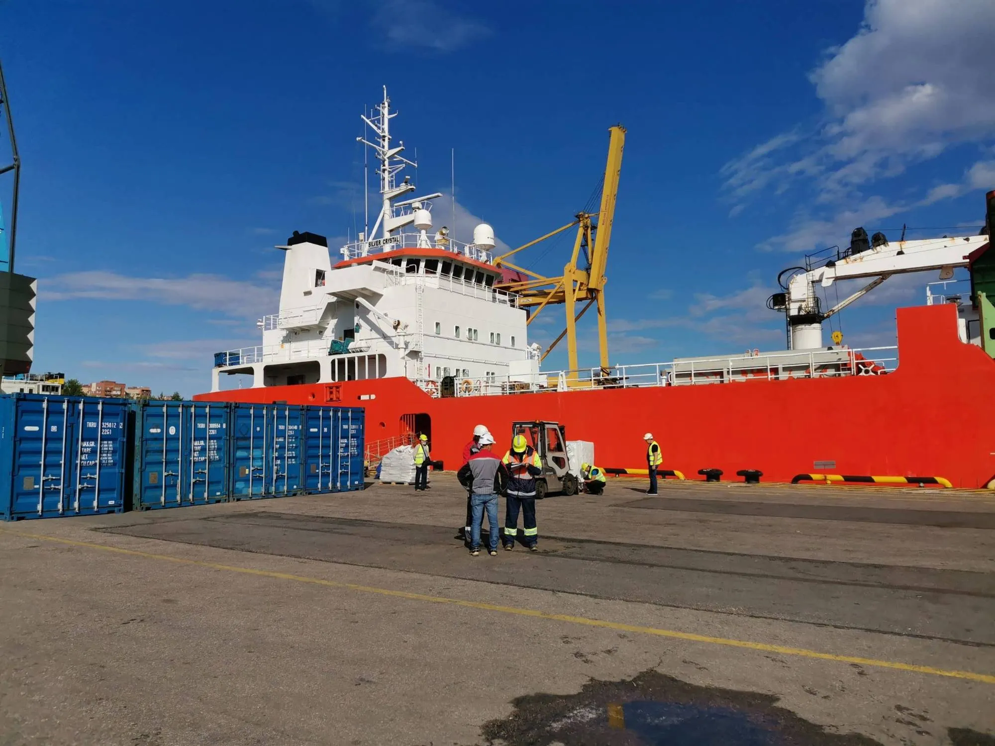 Cargo ship at the quay with containers in front