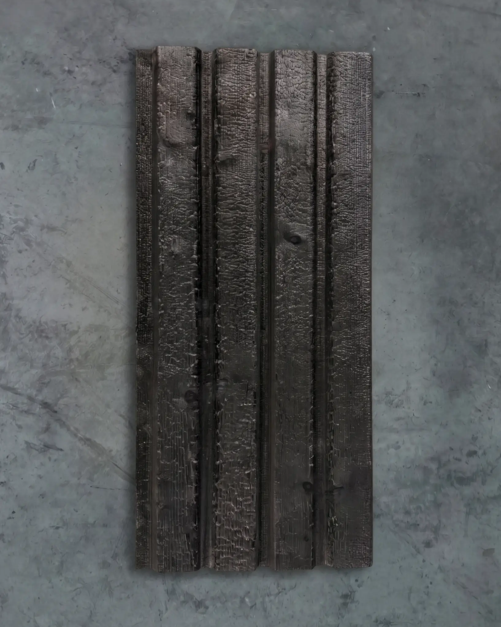 Charred Yakisugi cladding boards on a concrete floor
